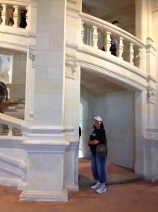 Mum in front of the double spiral staircase inside Chateau Chambord